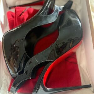 Christian Louboutin black patent sling back peep hole high heels.